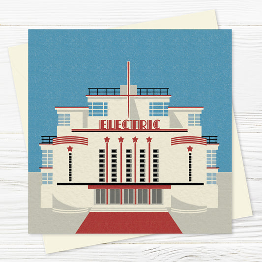 A greetings card and envelope featuring a stylised illustration of a symmetrical, streamlined cinema  in red and white. The word ELECTRIC is written across the front of the art deco facade. 